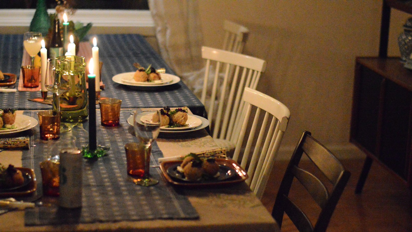 Table set with candles for a casual dinner party at home
