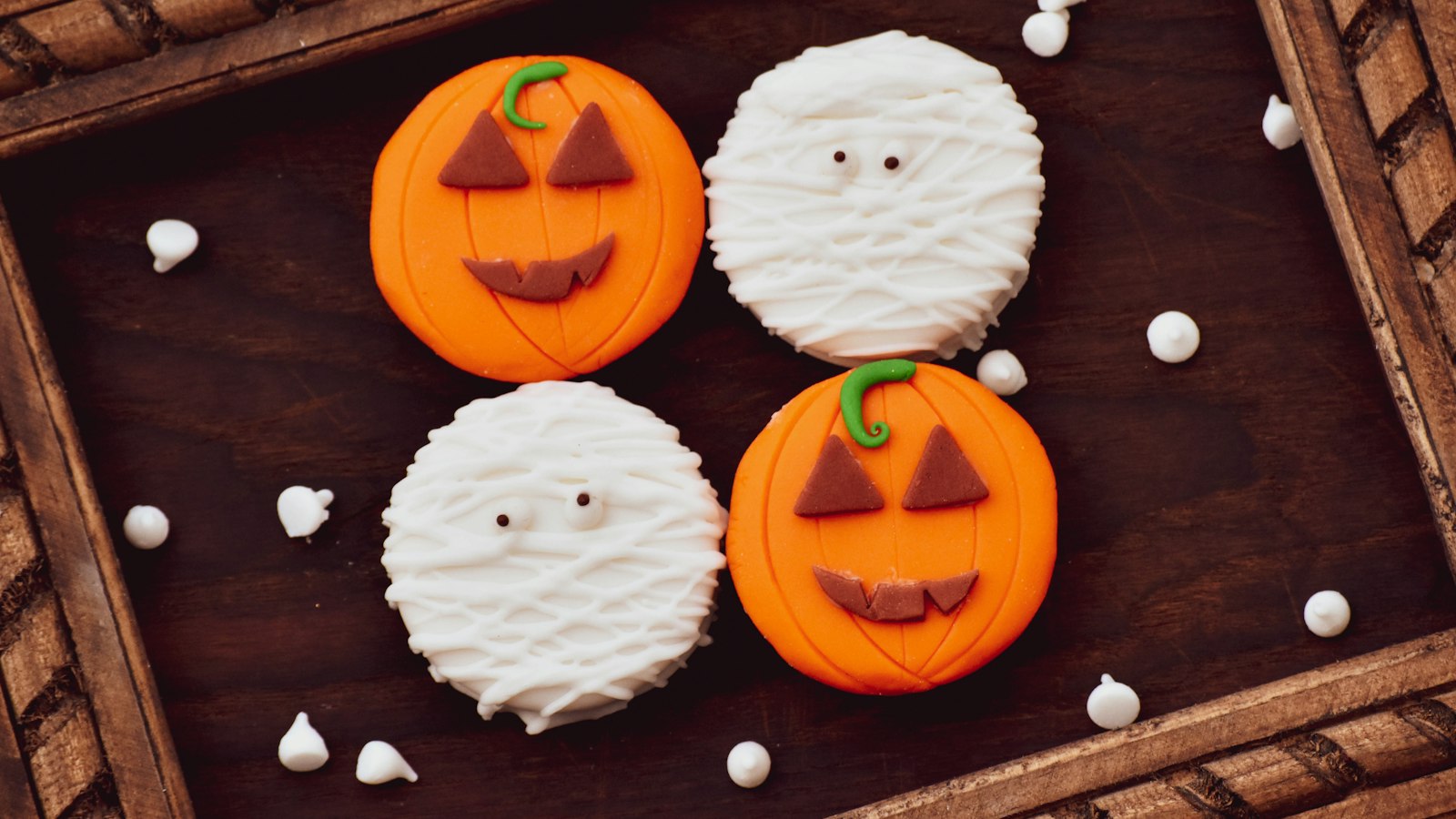 Pumpkin and mummy cookies for a Halloween potluck
